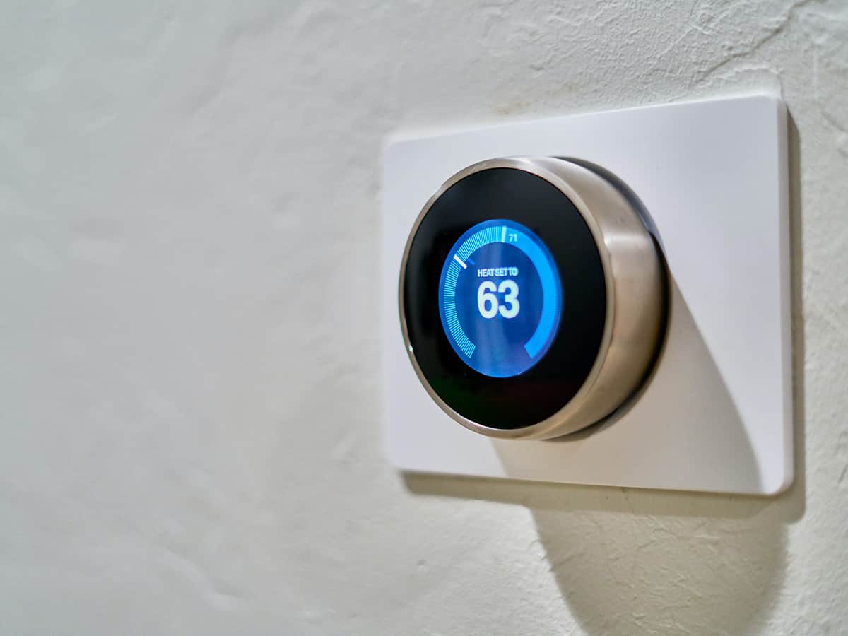 smart thermostat on wall set to 63