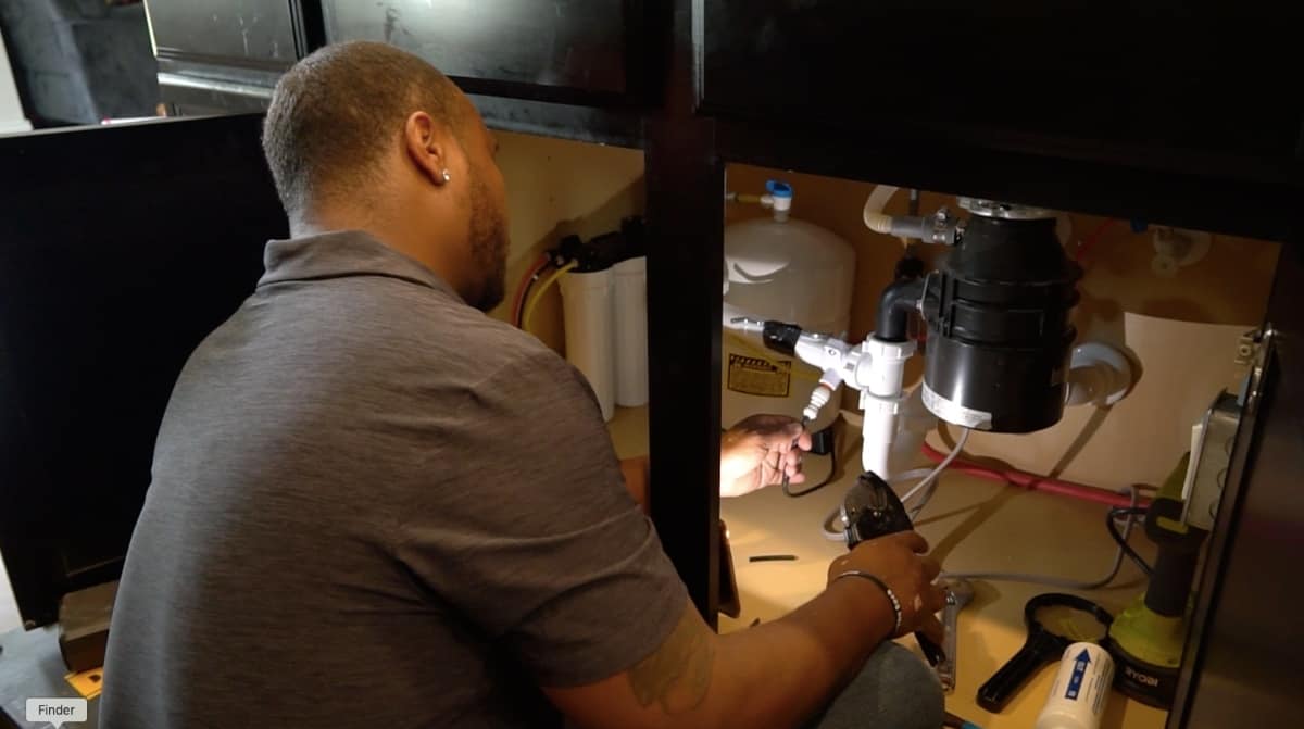 An ONIT water specialist installing a water filtration system for the whole home.