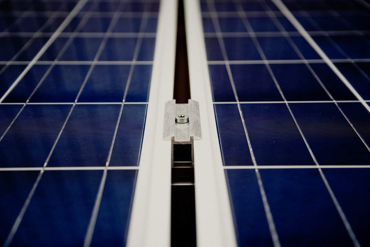 A closeup of dark blue solar panels installed on a roof.
