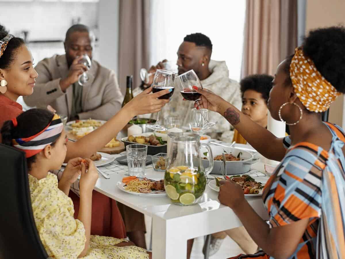 A large family sits at the dinner table for a meal.