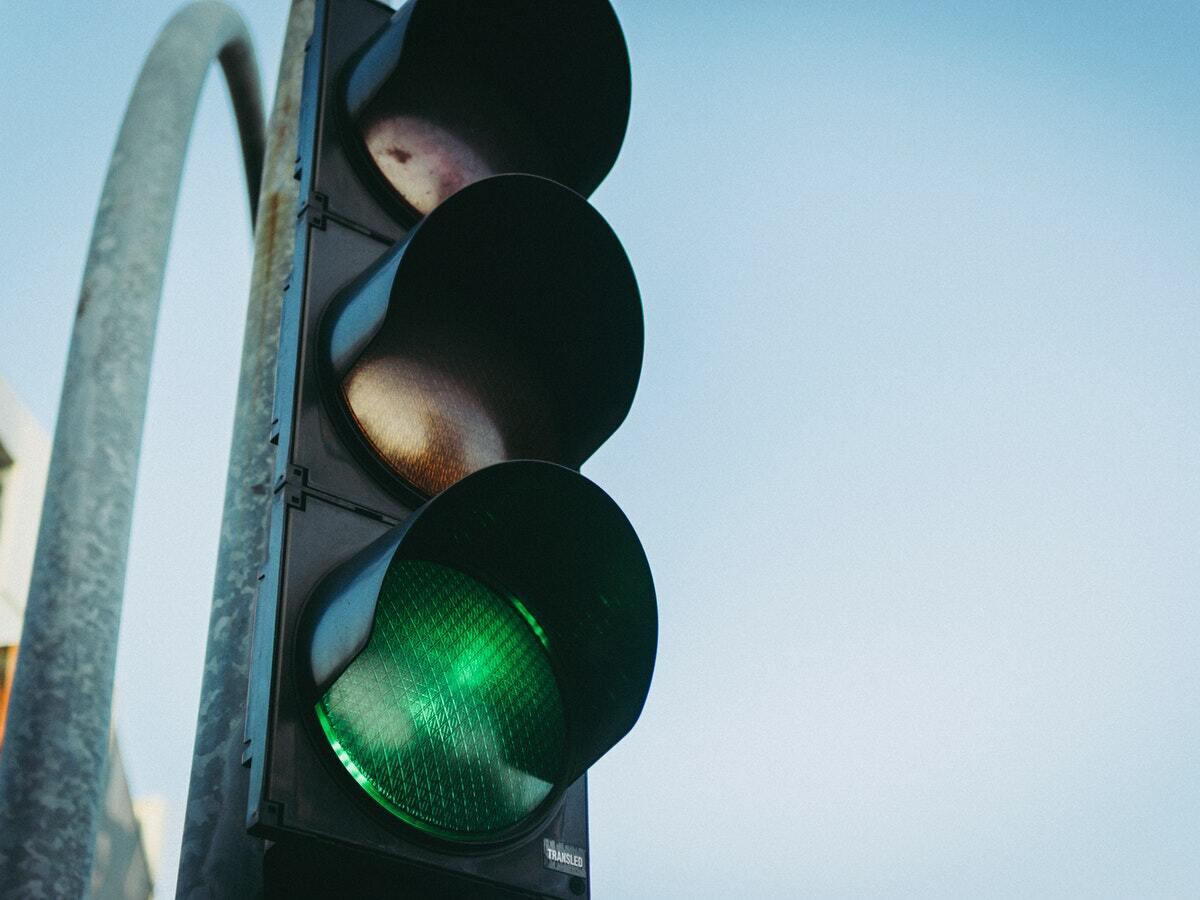 A traffic signal with a bright green light.