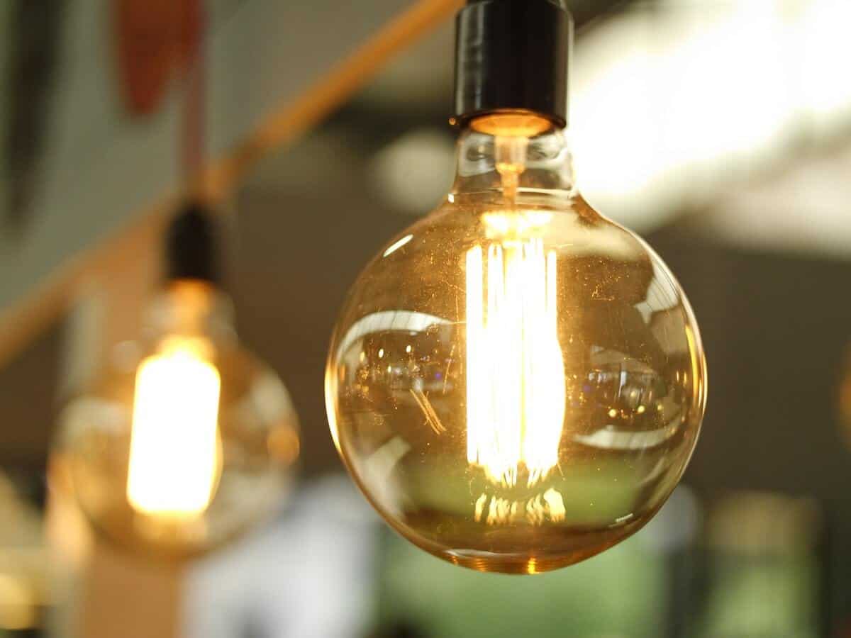 A close up of a clear glass bulb and the glowing light inside.