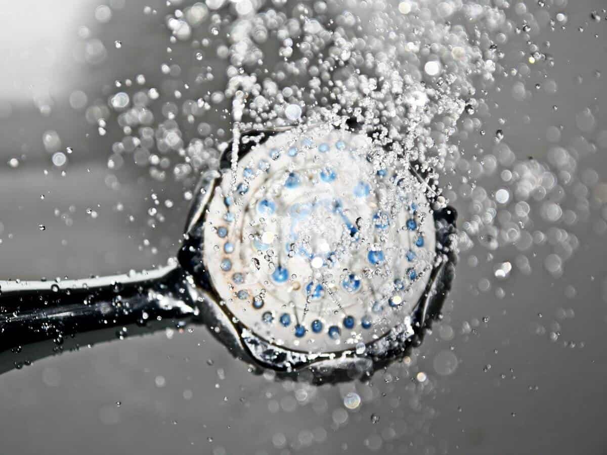 Water droplets sprinkling out of a shower head.