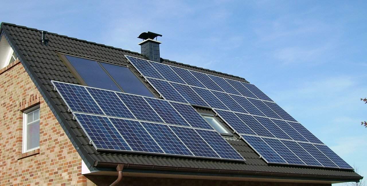 Dark blue solar panels installed on a black metal slate roof.