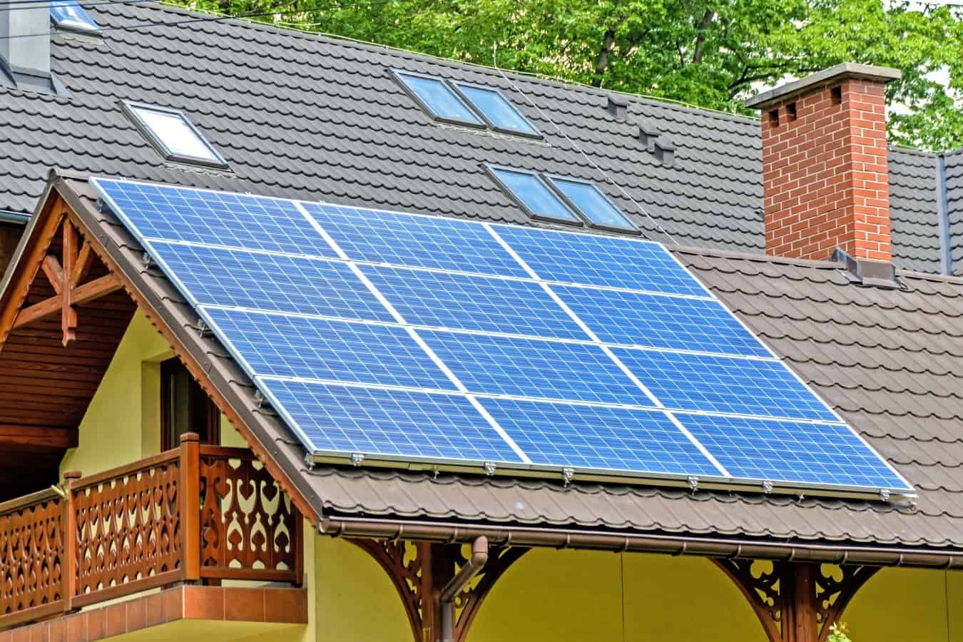 A solar panel grid installed on metal roof shingles.