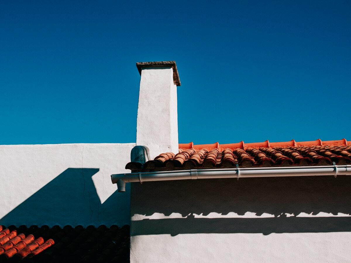 A Spanish style home with an orange tile roof.