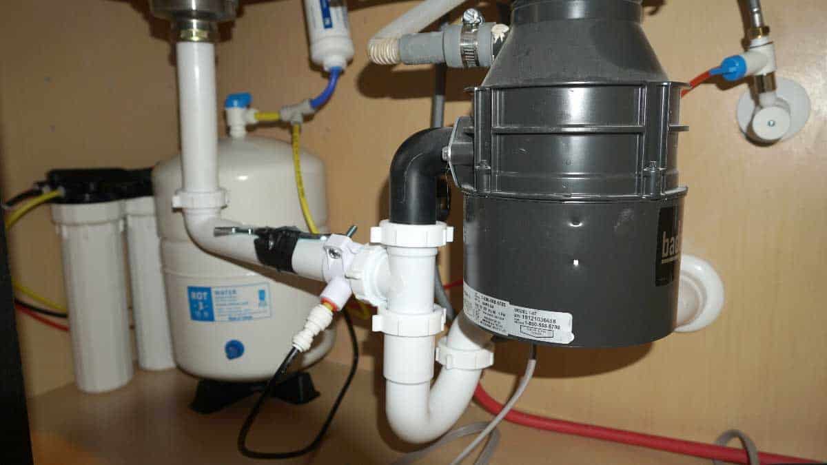 A water filtration system installed under a sink inside of a new home.