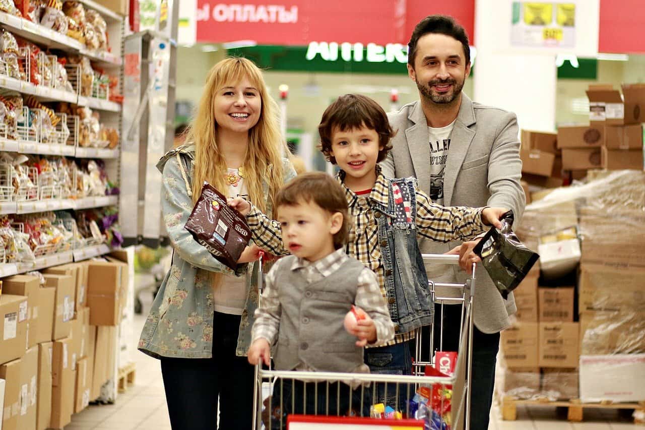 A young family shops in a grocery store.
