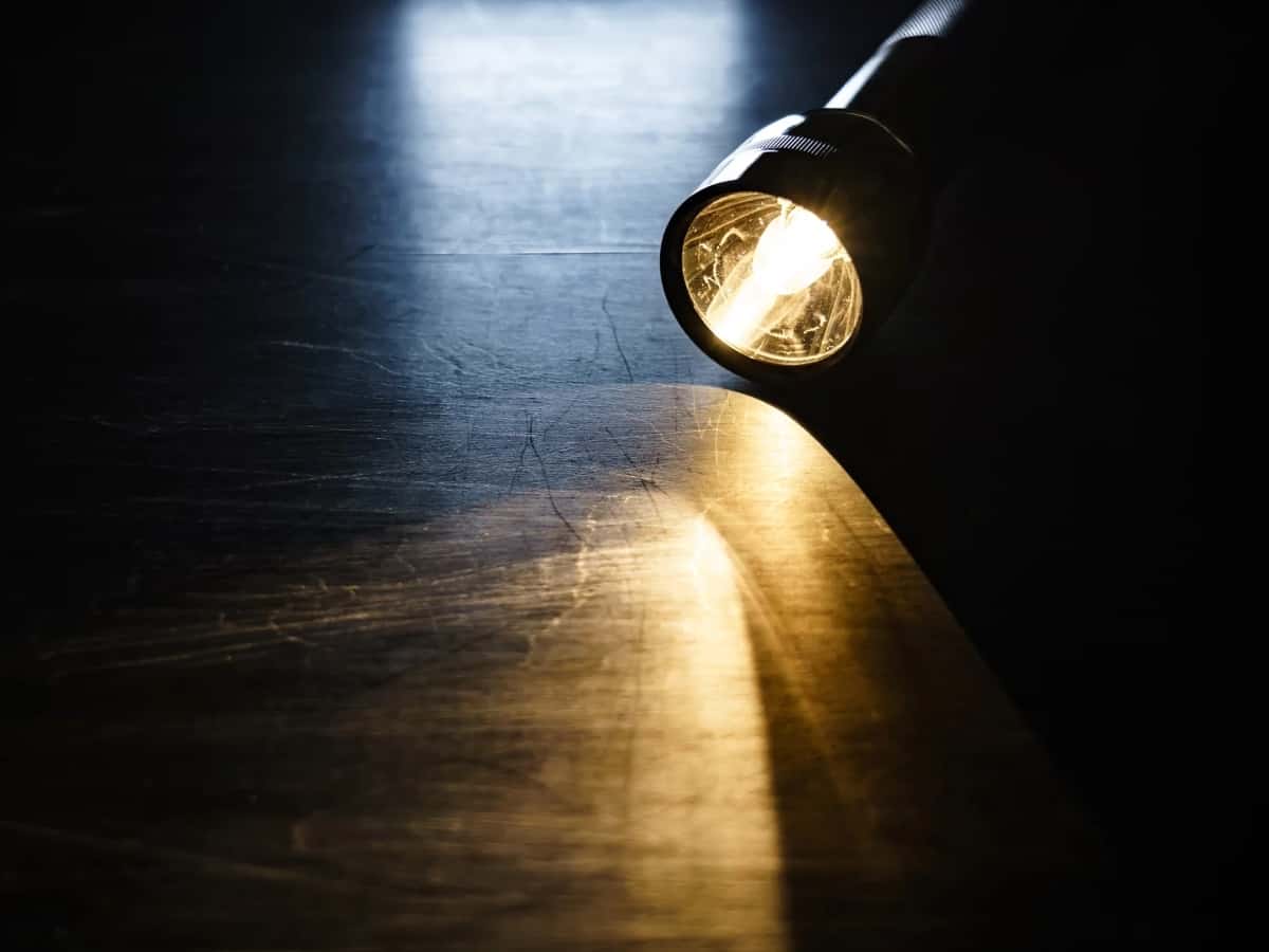 a close up of a flashlight on the ground during a power outage