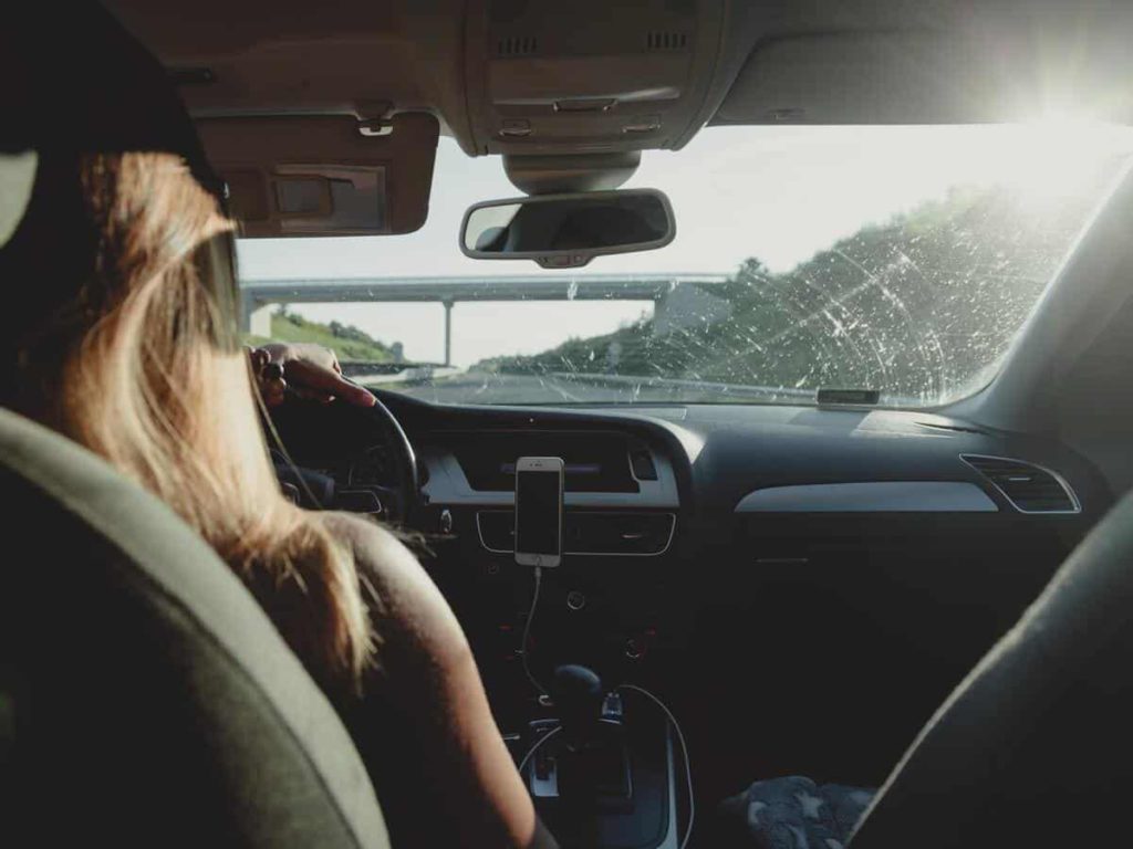 Over-the-shoulder view of a teen driving.