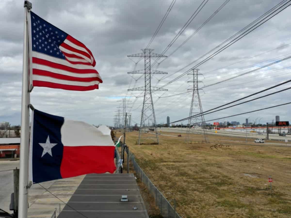 texas and american flag pointed towards electrical lines