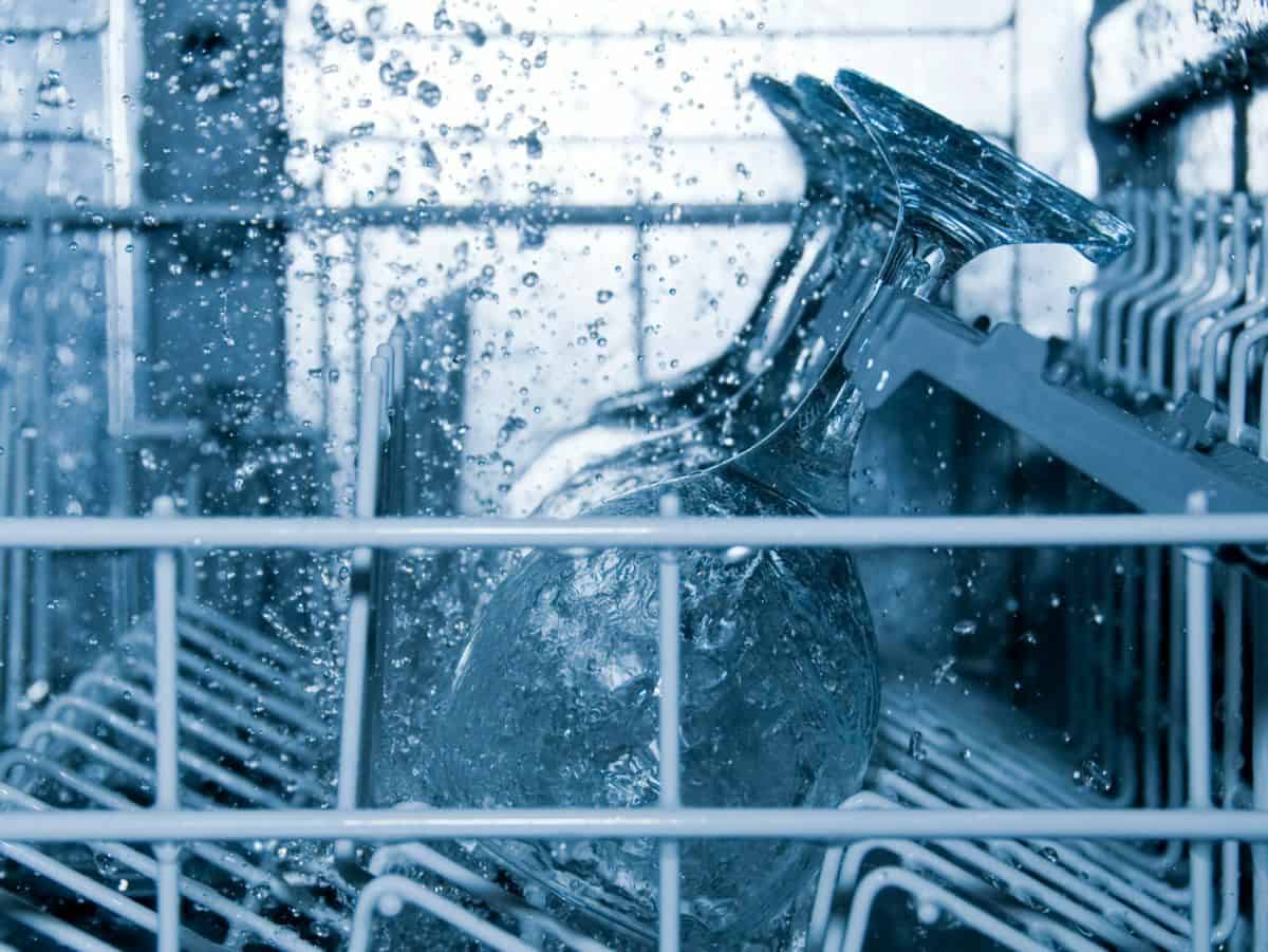 wine glasses in dishwasher with water droplets