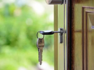 keys in front door, with green background