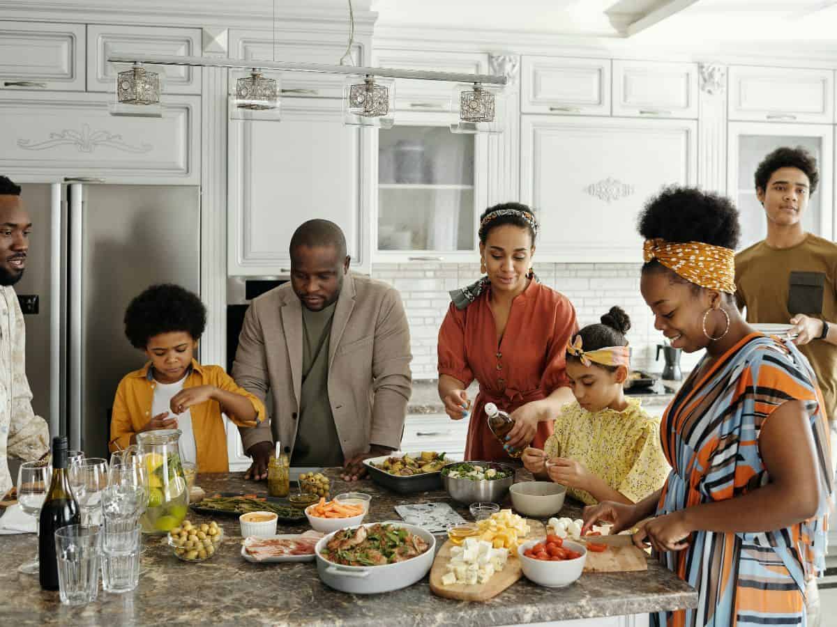 family in kitchen with food and water on the counter