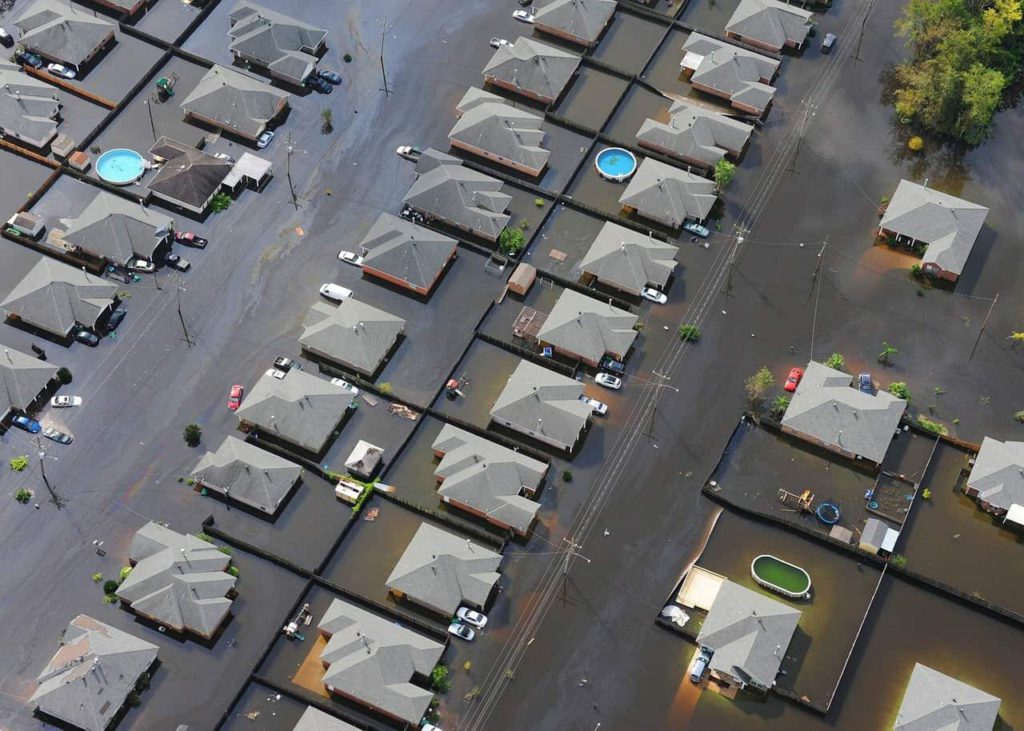 A bird's-eye view of a neighborhood flooded with water.