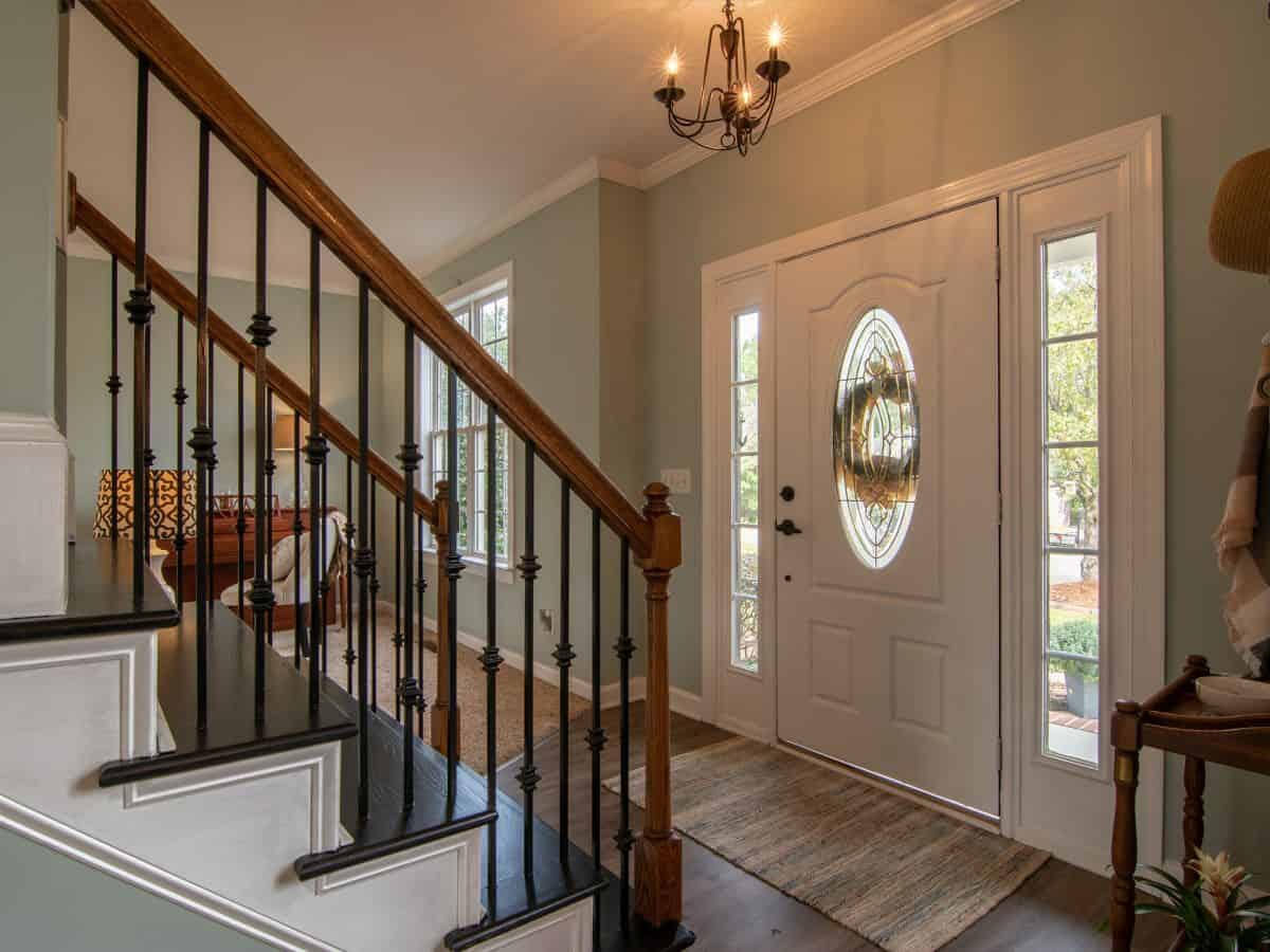 pov facing the front door of a house with stairs on left side