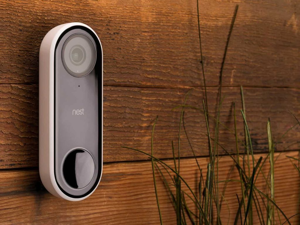 close up of the nest hello doorbell camera on wood wall