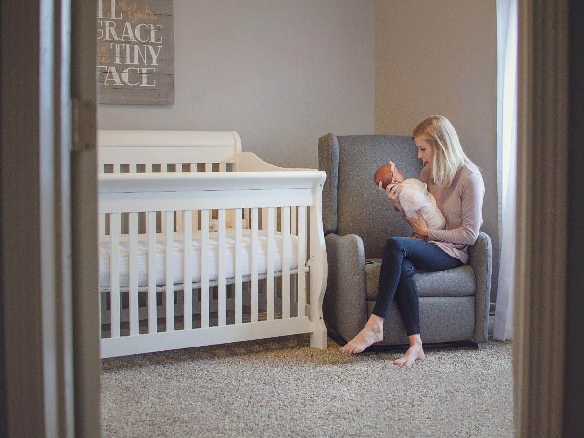 looking into a nursery with mother holding baby