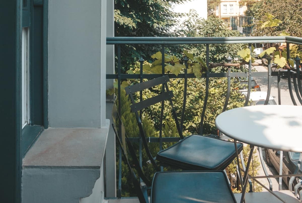 Patio chairs tucked into a table outside.