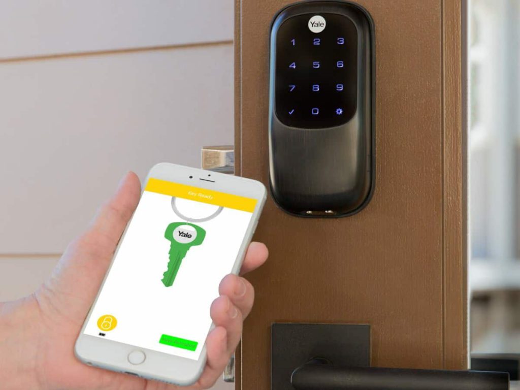 smart phone facing smart lock to unlock front door