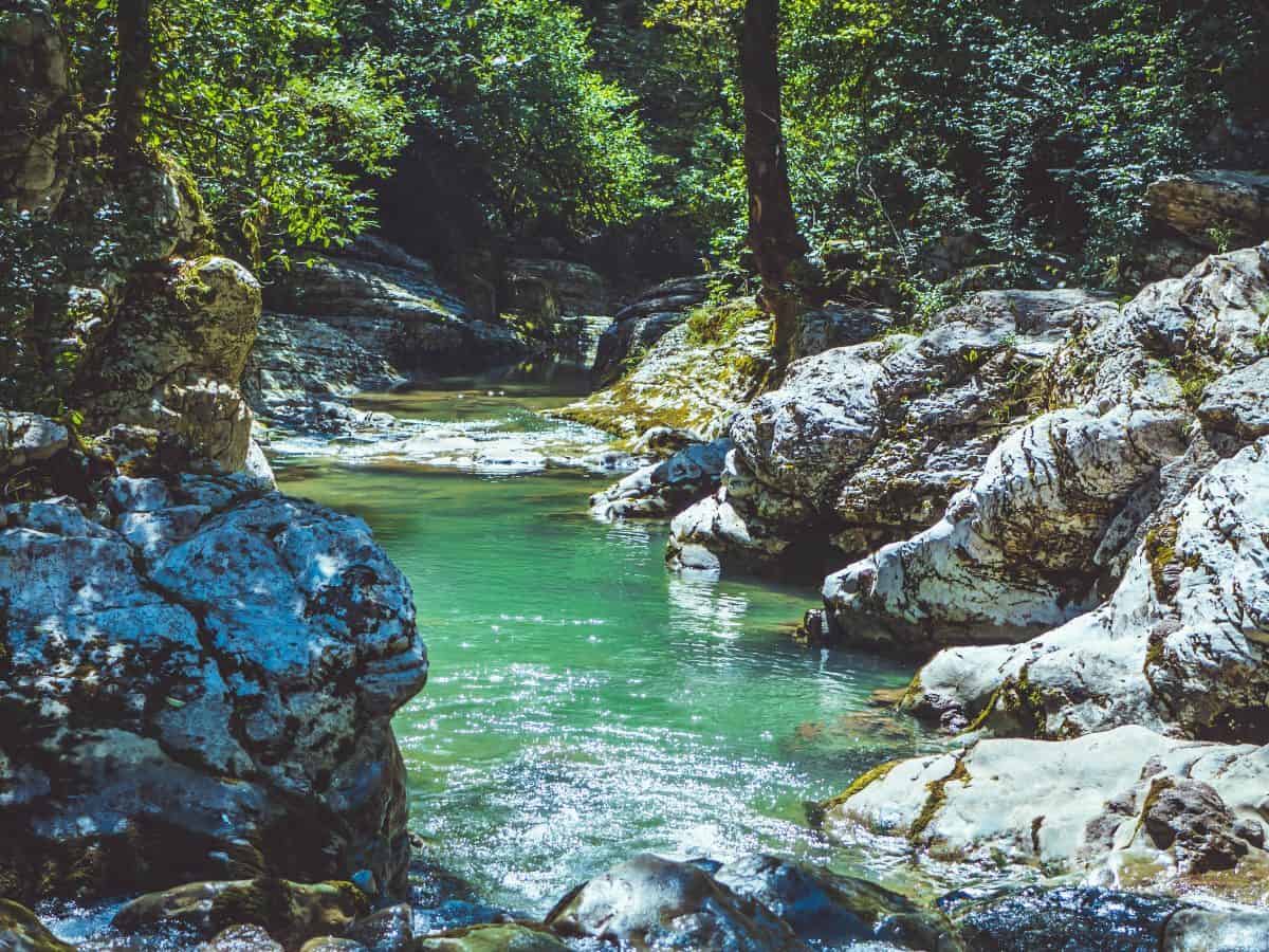 view of water between two large forms of rock, blue/green water, nature