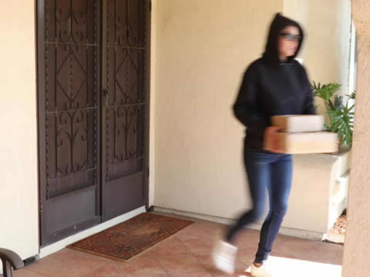 woman walking away with stolen package
