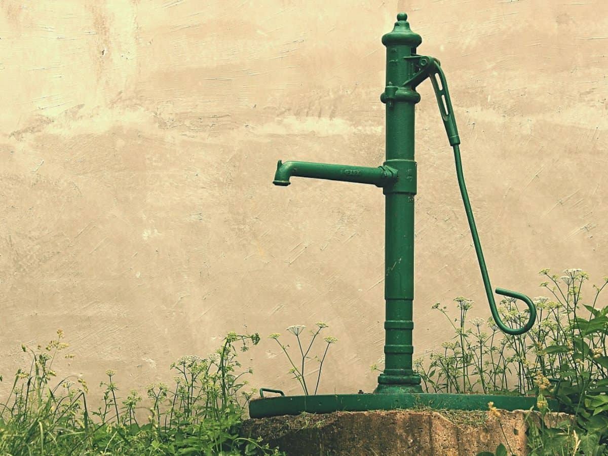 a green water well with pump