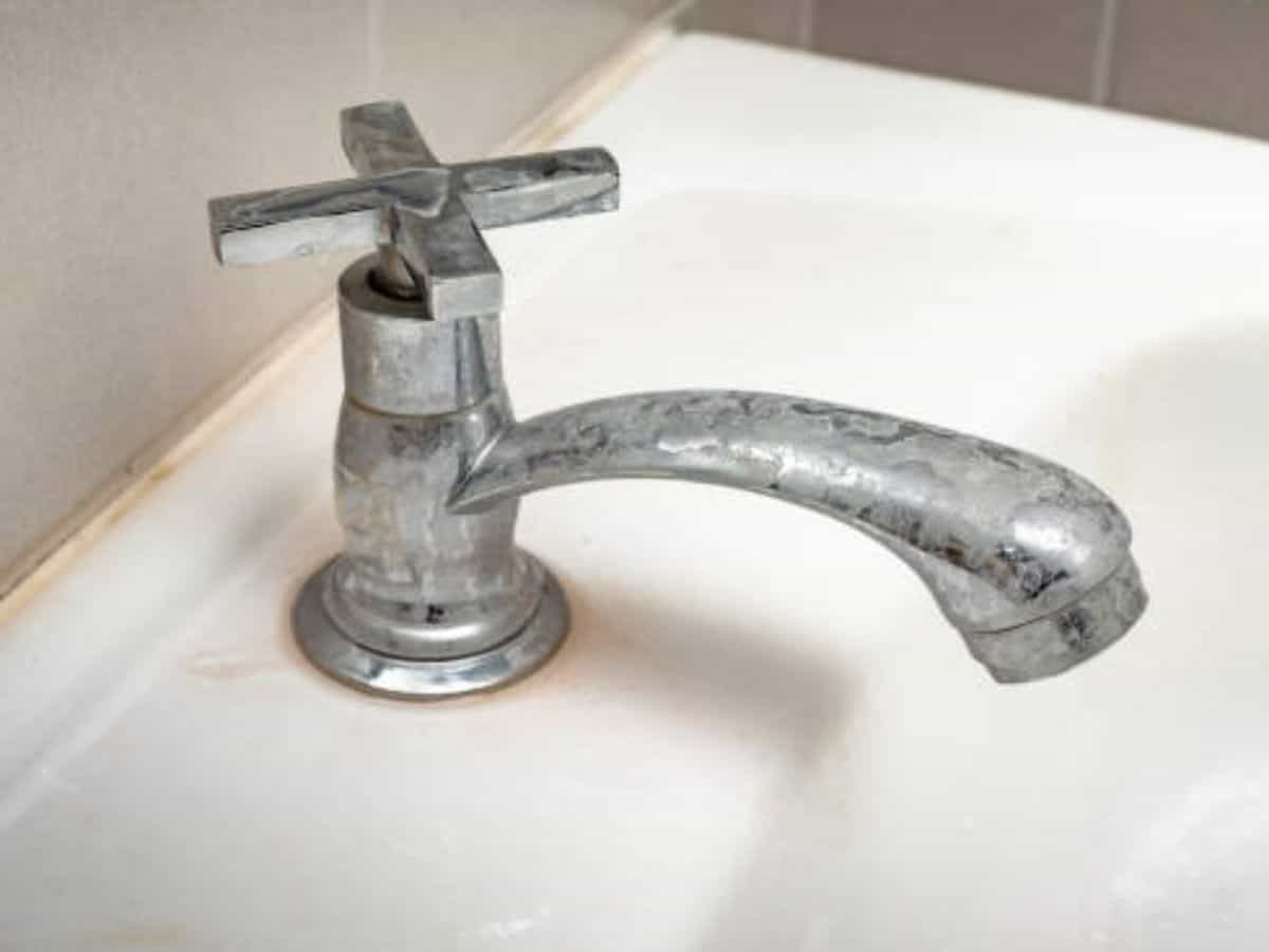 close up of hard water stain on bathroom faucet