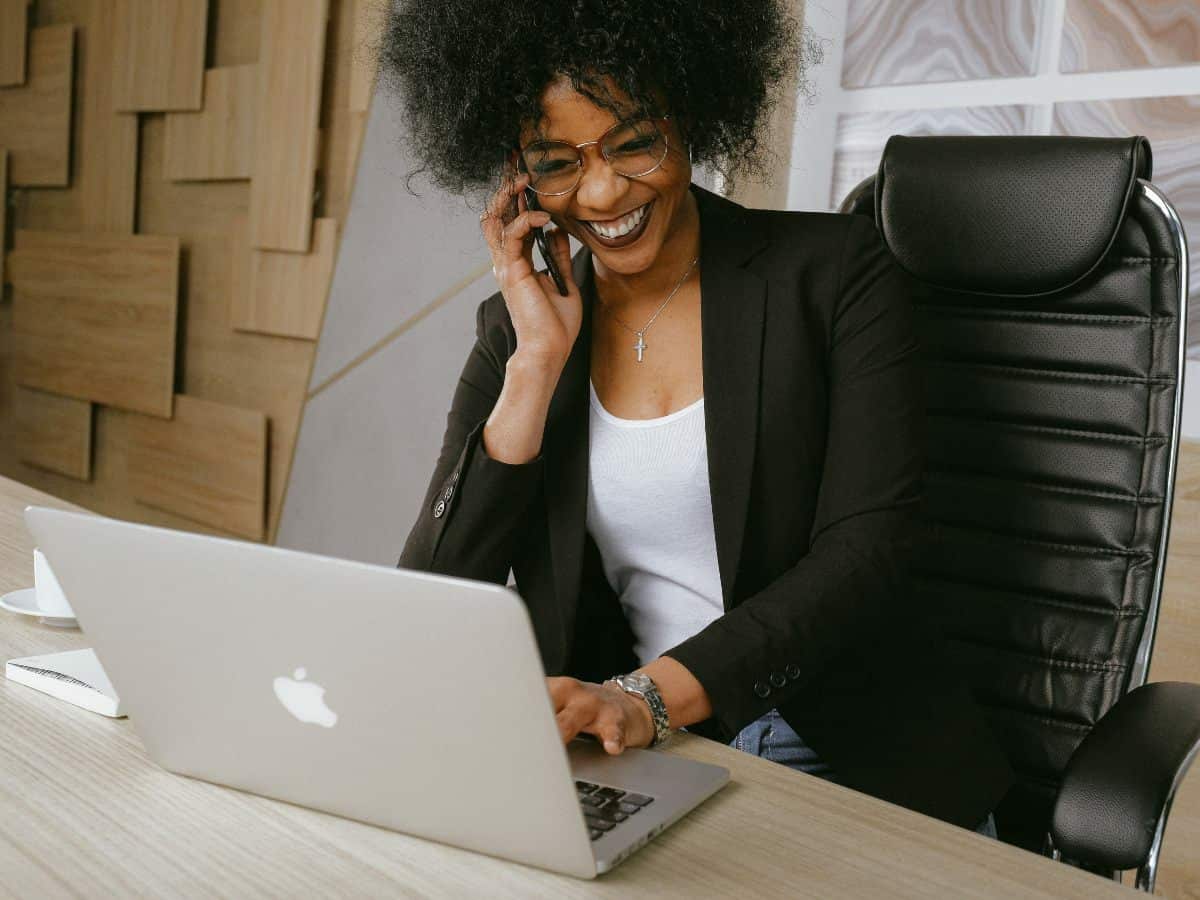 talking on the phone with laptop that is open