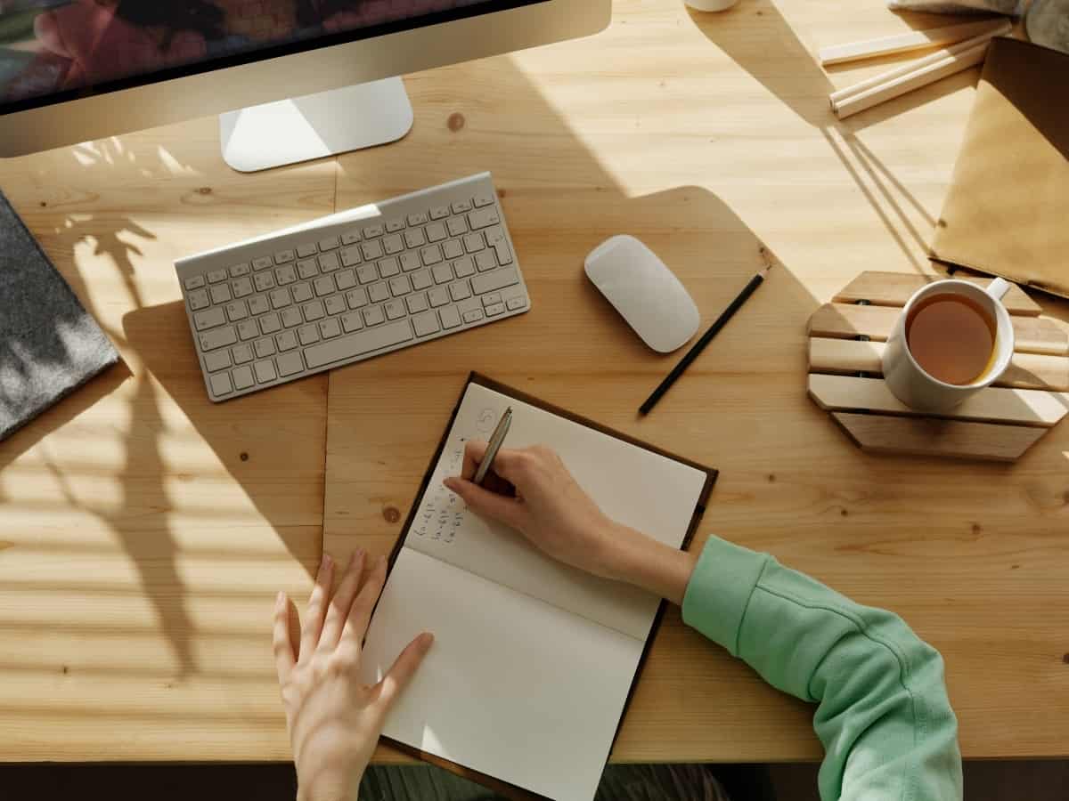 aerial overview of notebook and pen