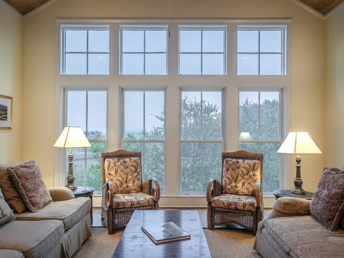 large window in living room, with two sitting chairs and two couches