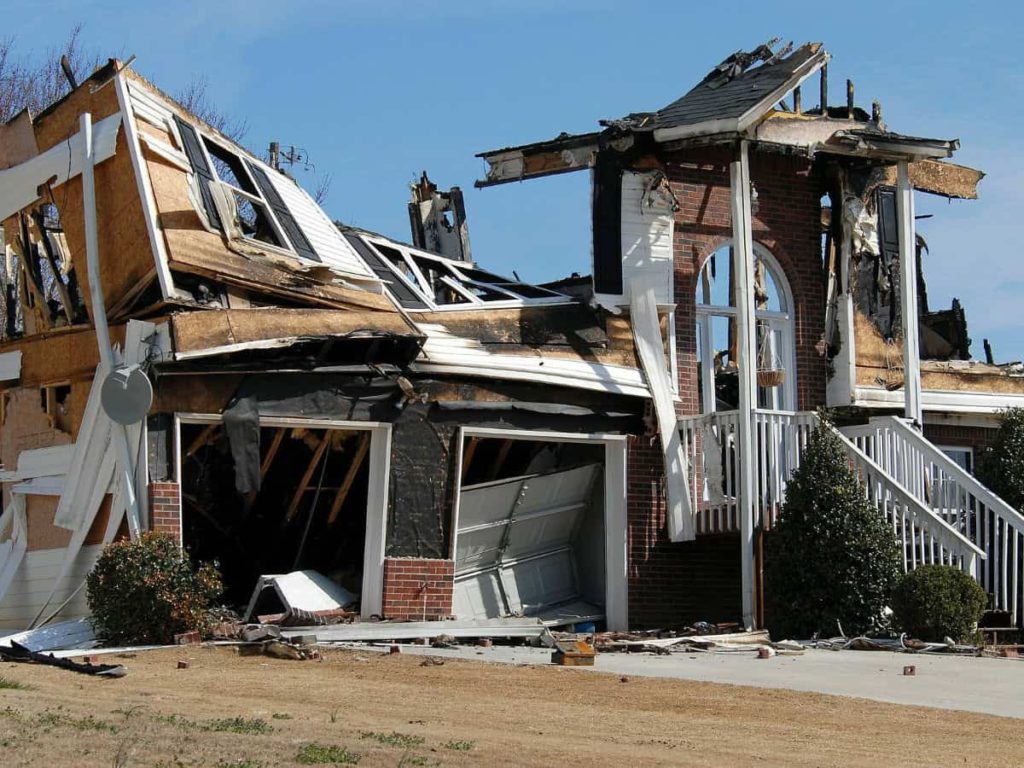 a collapsed home structure after a fire