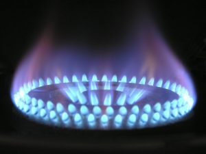 Flames glowing out of a gas burner stovetop.