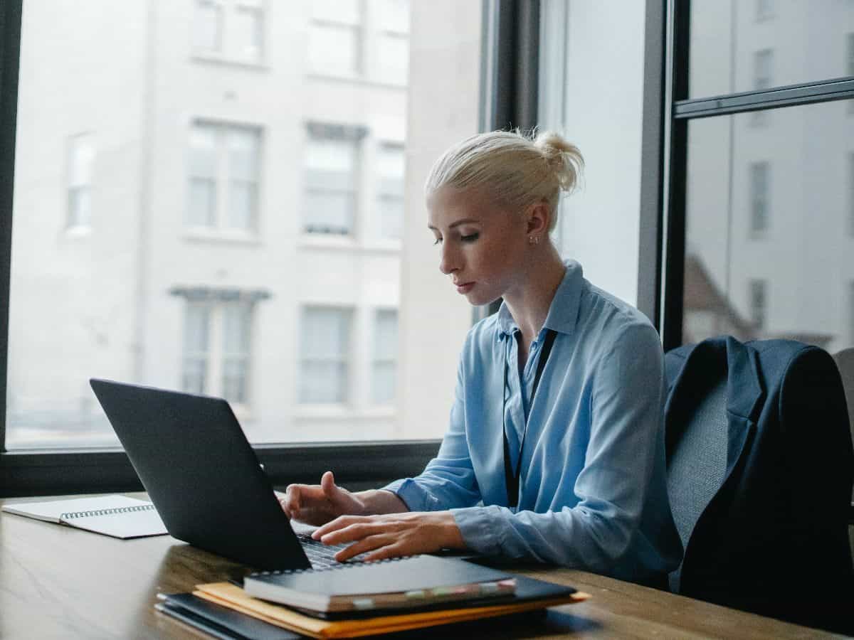 blonde woman in her office at work, on her laptop
