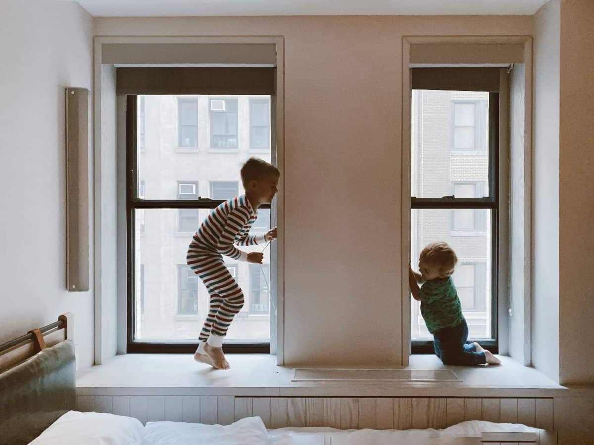 two kids in the window playing
