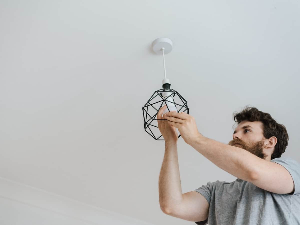 man installing light bulb into new feature