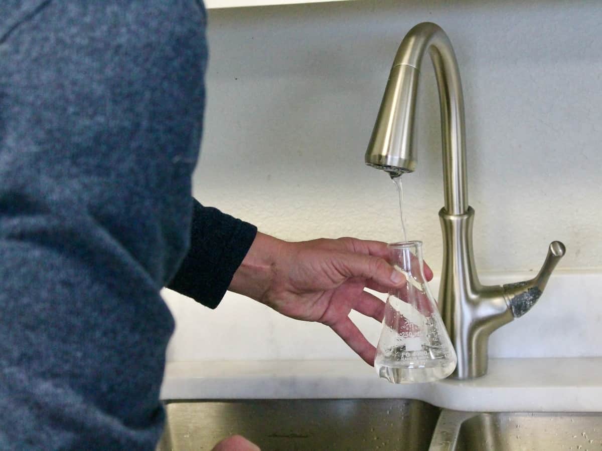 filling vial with water for a water test