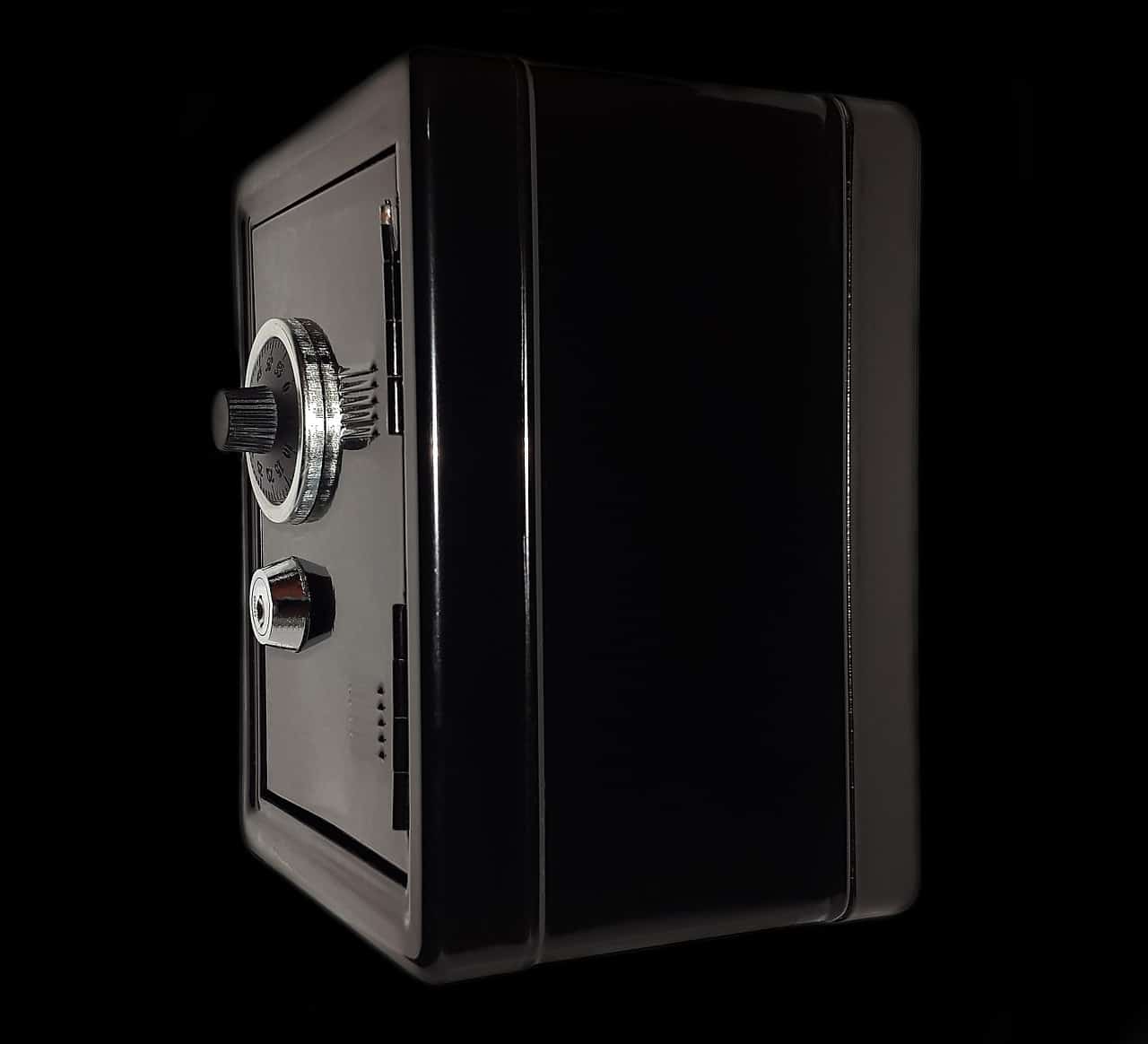 A black home safe box sitting against a black background.