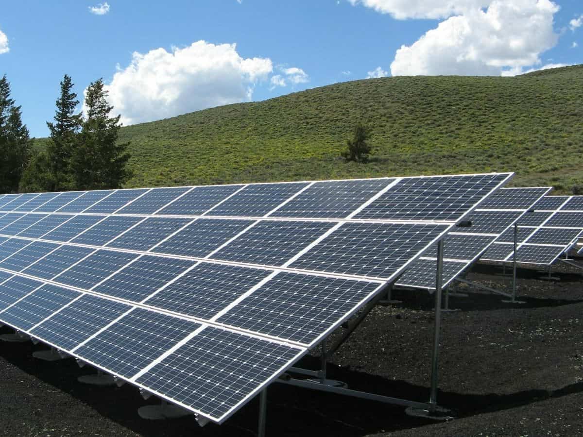 rows of tilted solar panels in a field