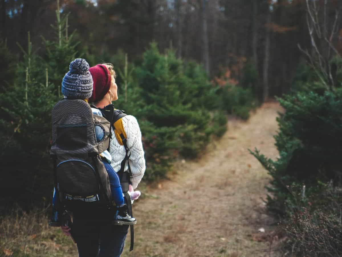 mom with baby on back while hiking