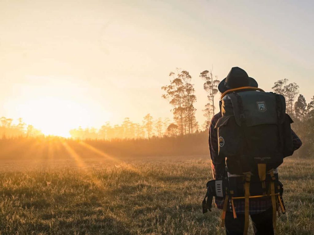 backpacking and walking into sun