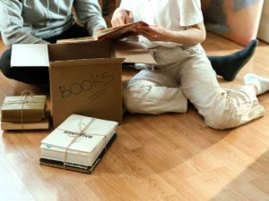 unpacking box of books in home