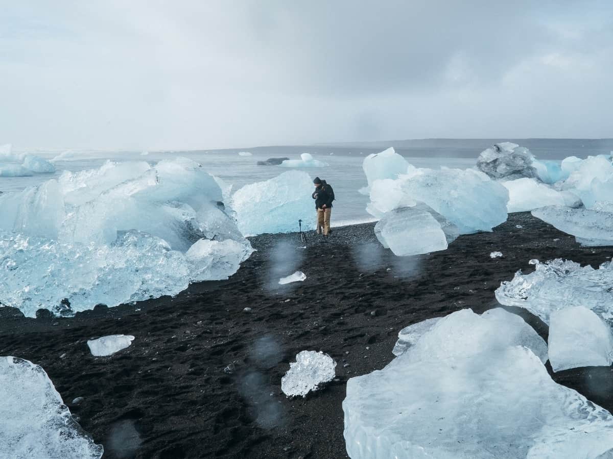 man standing in melted ice cap as a result of climate change