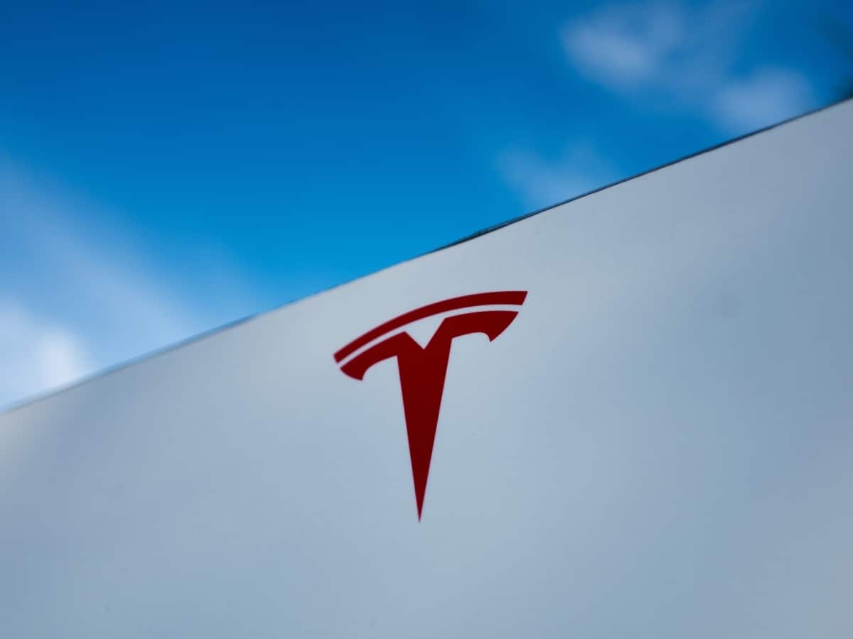 the red tesla logo on a white building