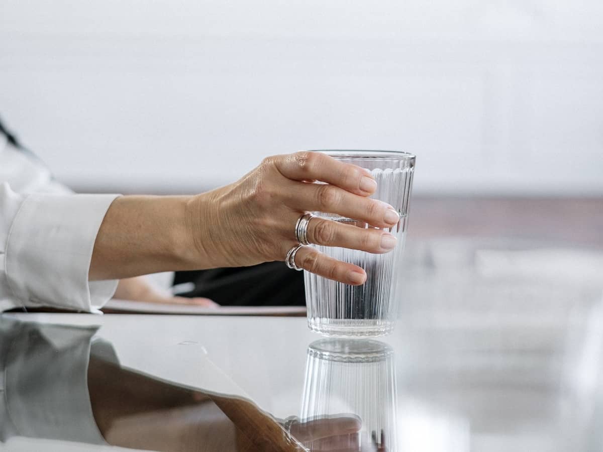 hand holding glass of water