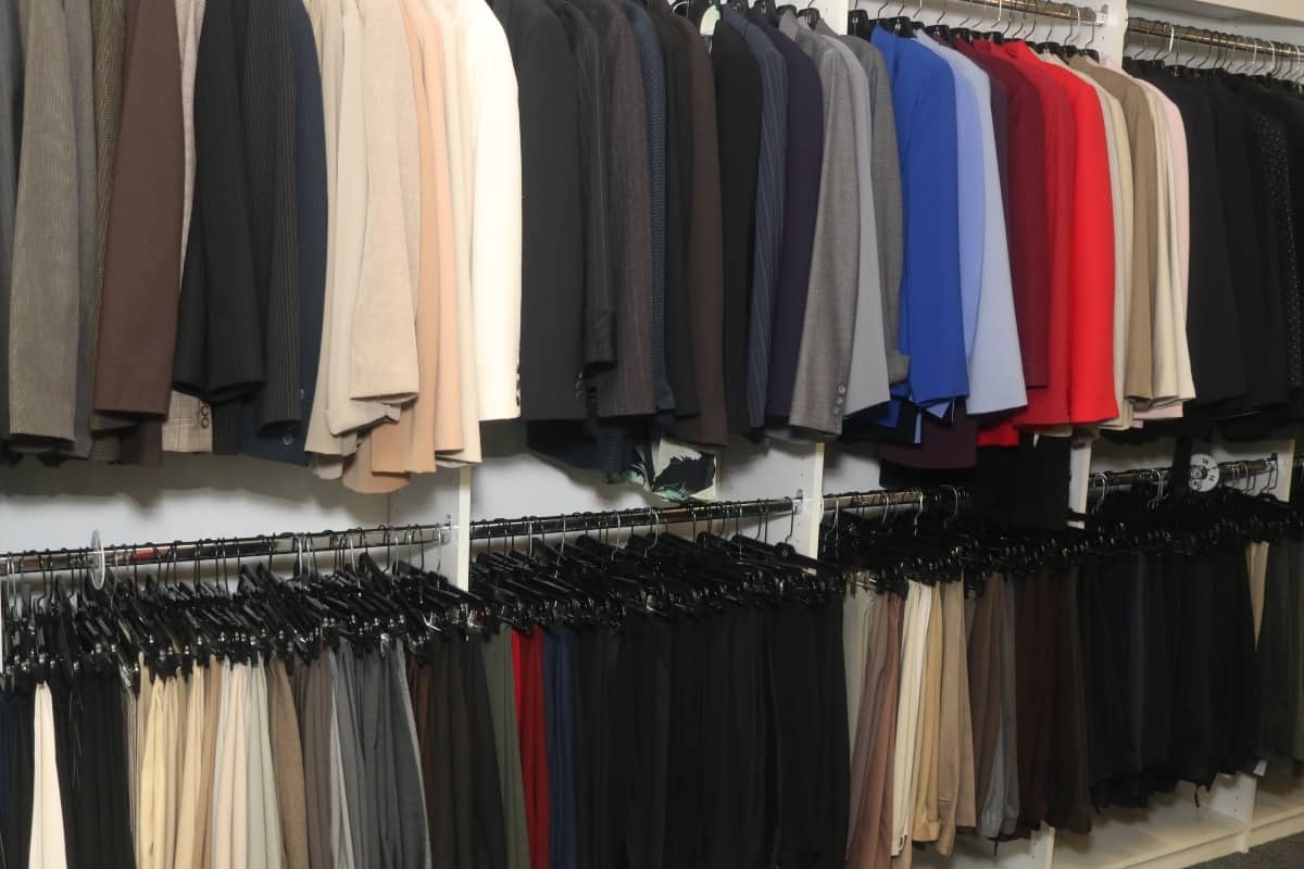 Attitudes and Attire boutique with an assortment of professional clothing hanging on hangers.