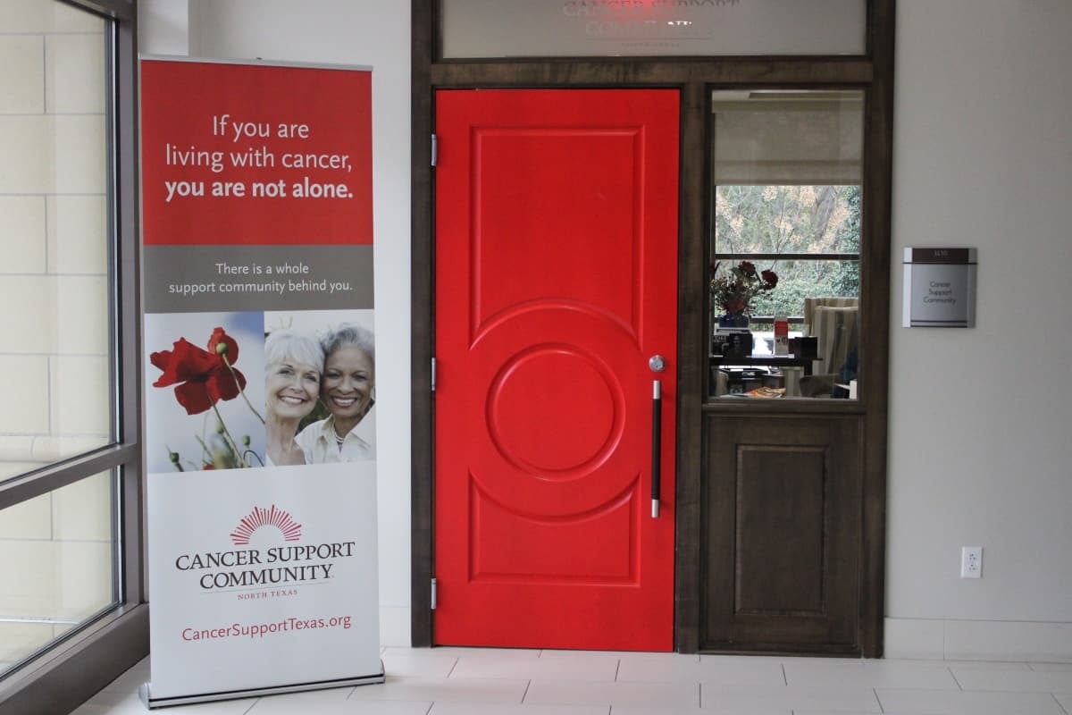 A red door at the front of a Cancer Support Community North Texas clubhouse.