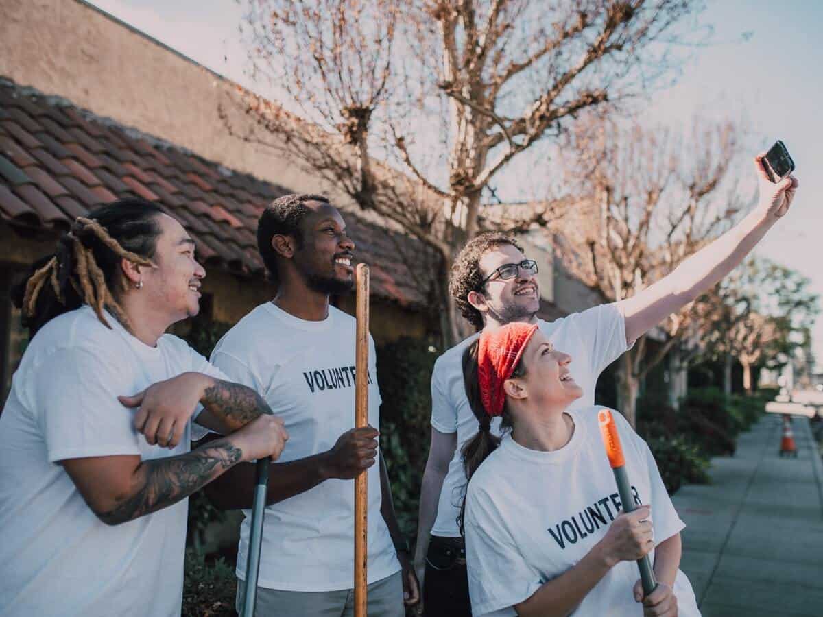 A group of young volunteers are gathered together for a selfie.