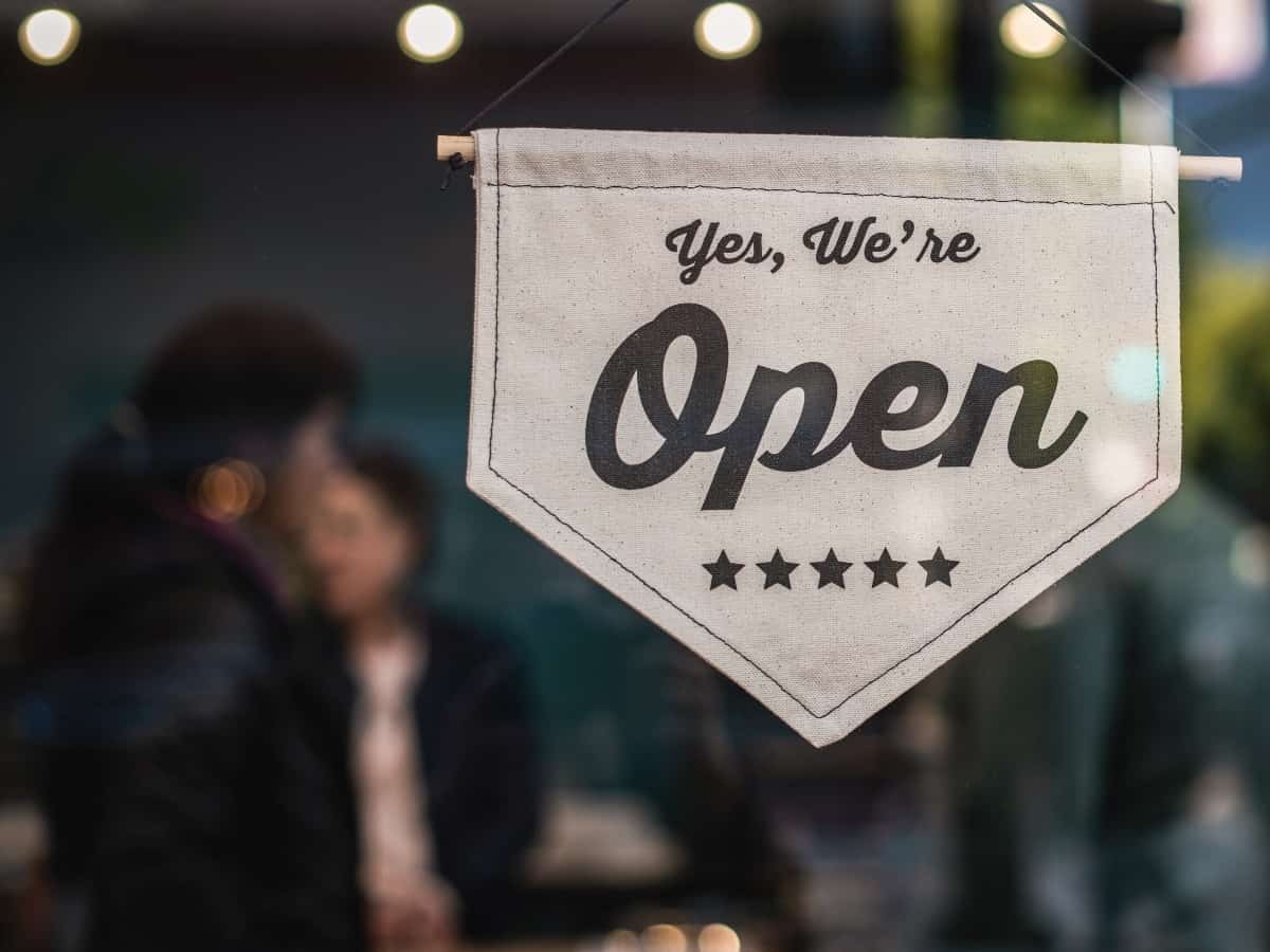 a "yes we're open" sign used for dallas small businesses