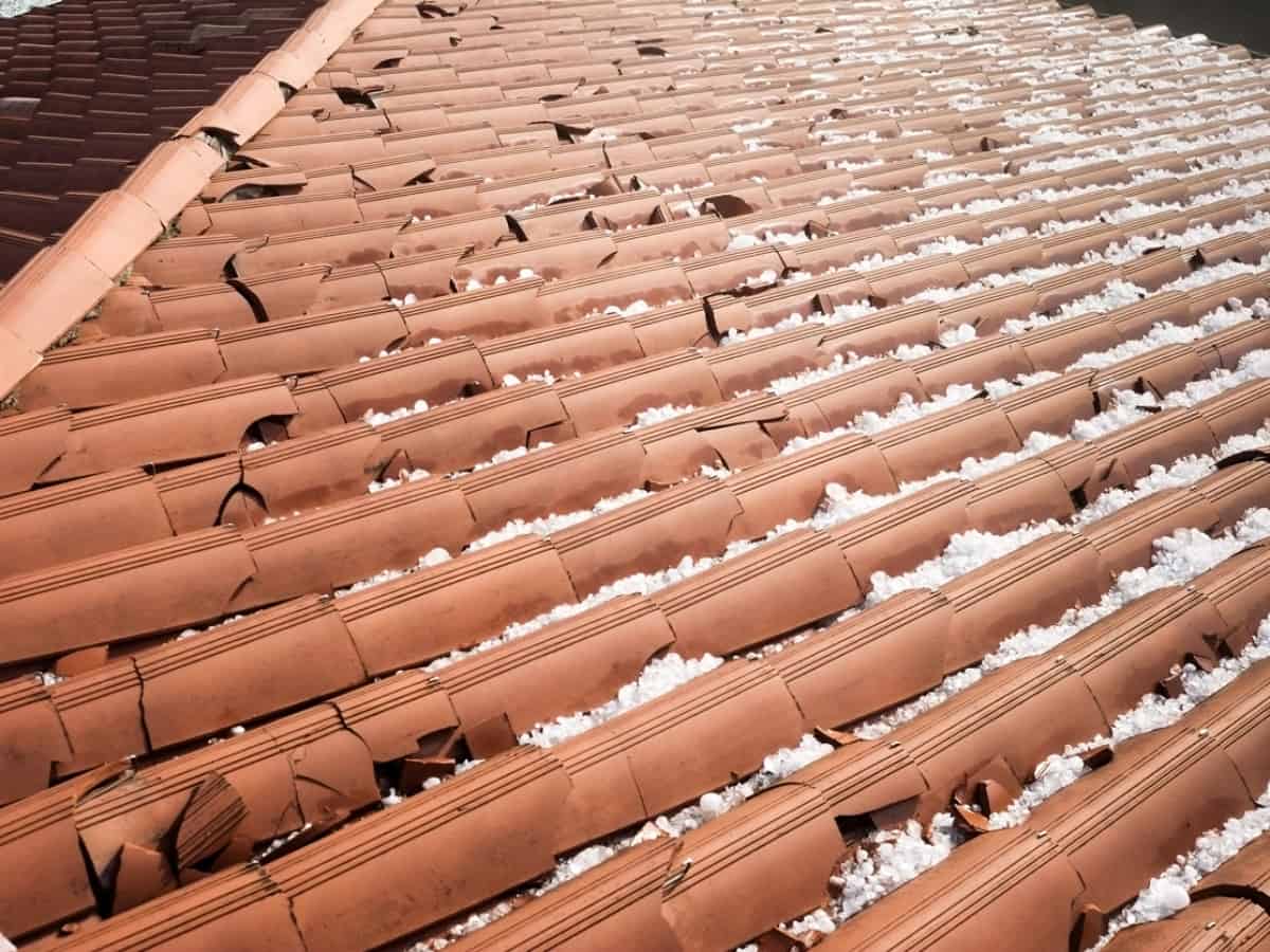an orange roof with hail damage and remaining hail